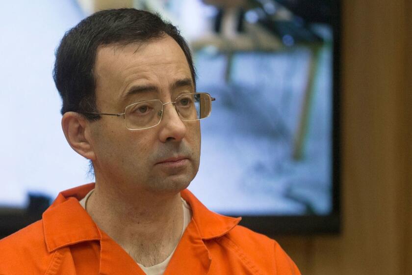 (FILES) In this file photo taken on February 5, 2018 former Michigan State University and USA Gymnastics doctor Larry Nassar appears in court for his final sentencing phase in Eaton County Circuit Court in Charlotte, Michigan. - American lawmakers made 15 recommendations to the US Olympic Committee on December 20, 2018 to better safeguard athletes from sexual abuse in the wake of the Larry Nassar gymnastics scandal. Suggestions by the House of Representatives Energy and Commerce Committee in its 133-page report included more USOC punishment options for 48 national sport governing bodies and open talk about sexual abuse without non-disclosure deals. (Photo by RENA LAVERTY / AFP)RENA LAVERTY/AFP/Getty Images ** OUTS - ELSENT, FPG, CM - OUTS * NM, PH, VA if sourced by CT, LA or MoD **