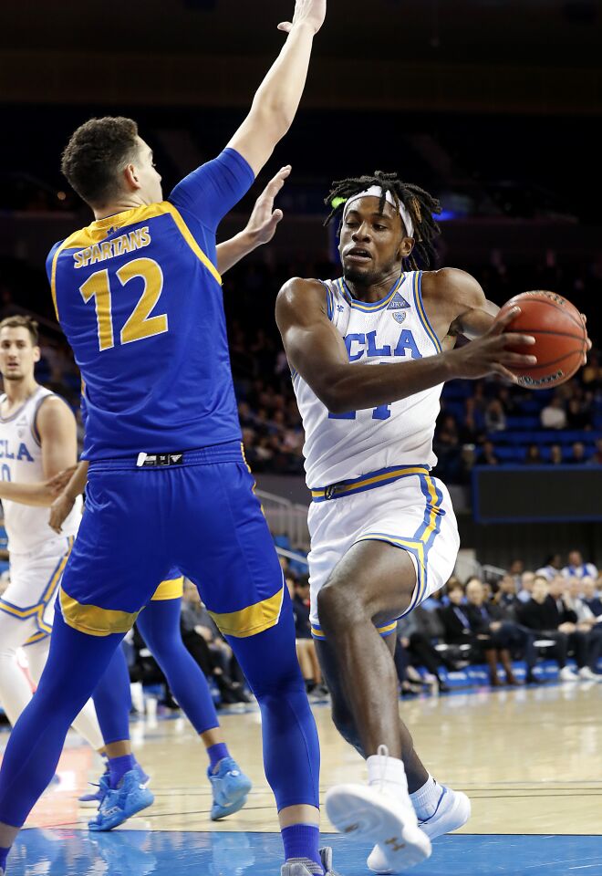 UCLA forward Jalen Hill goes to the basket against San Jose State forward Eduardo Lane.