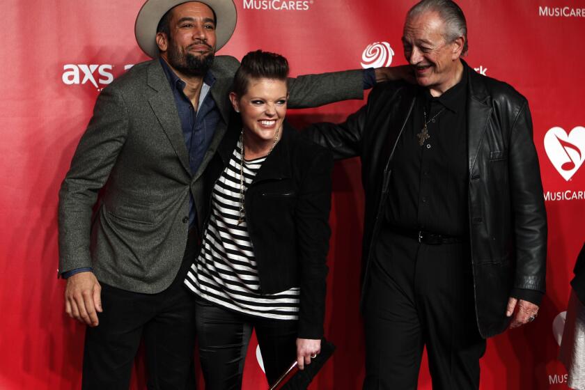 Natalie Maines, here with Ben Harper, left, and bluesman Charlie Musselwhite at the 2013 MusiCares salute to Bruce Springsteen, has released her first solo album, "Mother."