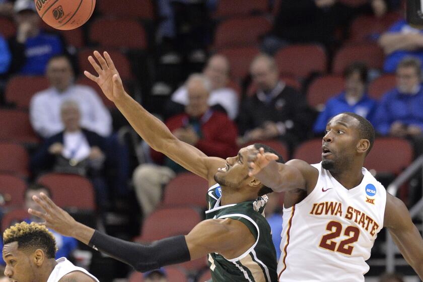 UAB's Robert Brown' left, and Iowa State's Dustin Hogue battle for a loose ball in the first half Thursday. The Blazers would upset the third-seeded Cyclones, 60-59.