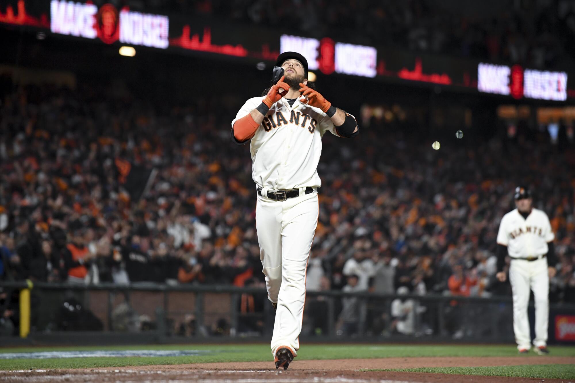 San Francisco Giants' Brandon Crawford celebrates while crossing home off a solo home run