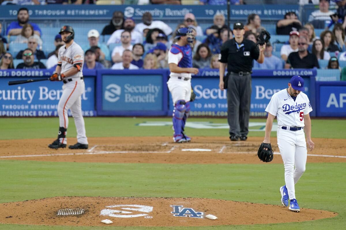 San Francisco's J.D. Davis, left, admires his grand slam off Dodgers reliever Alex Vesia on June 17, 2023.