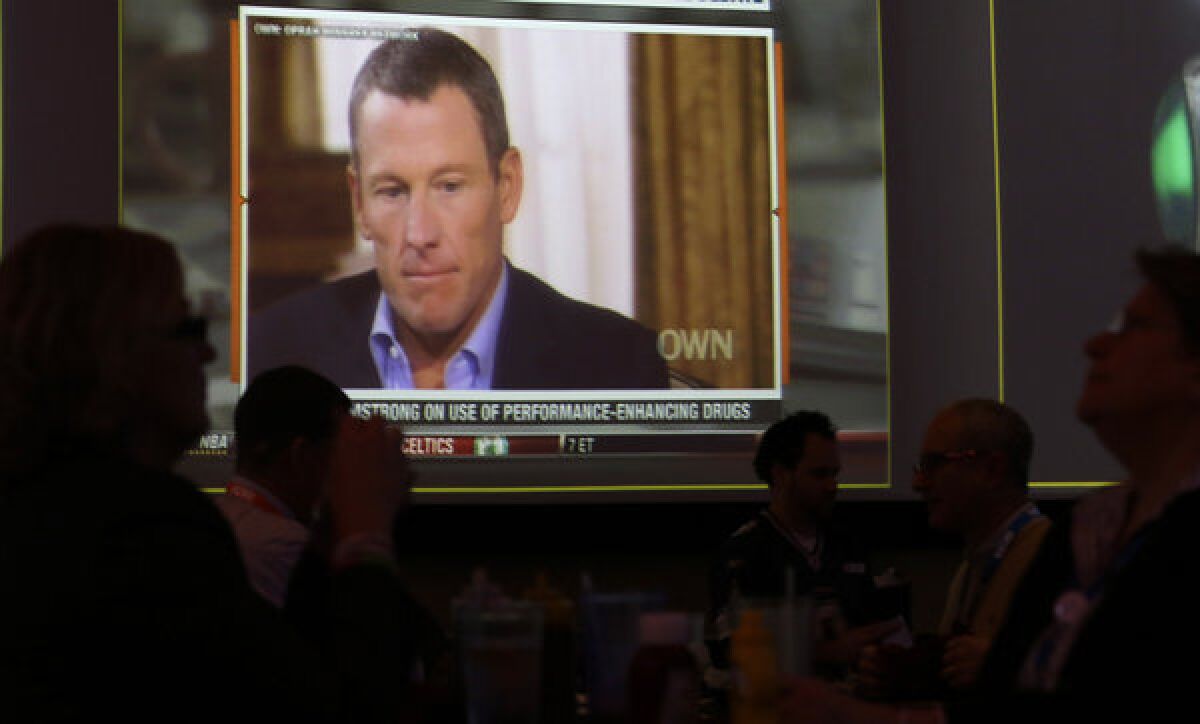 A video screen at a hotel restaurant in Grapevine, Texas, Friday, Jan. 18, 2013, shows a replay telecast of a segment of Lance Armstrong being interviewed by Oprah Winfrey.