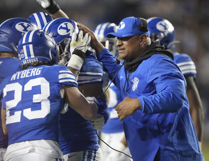 BYU coach Kalani Sitake celebrates a turnover with his players.