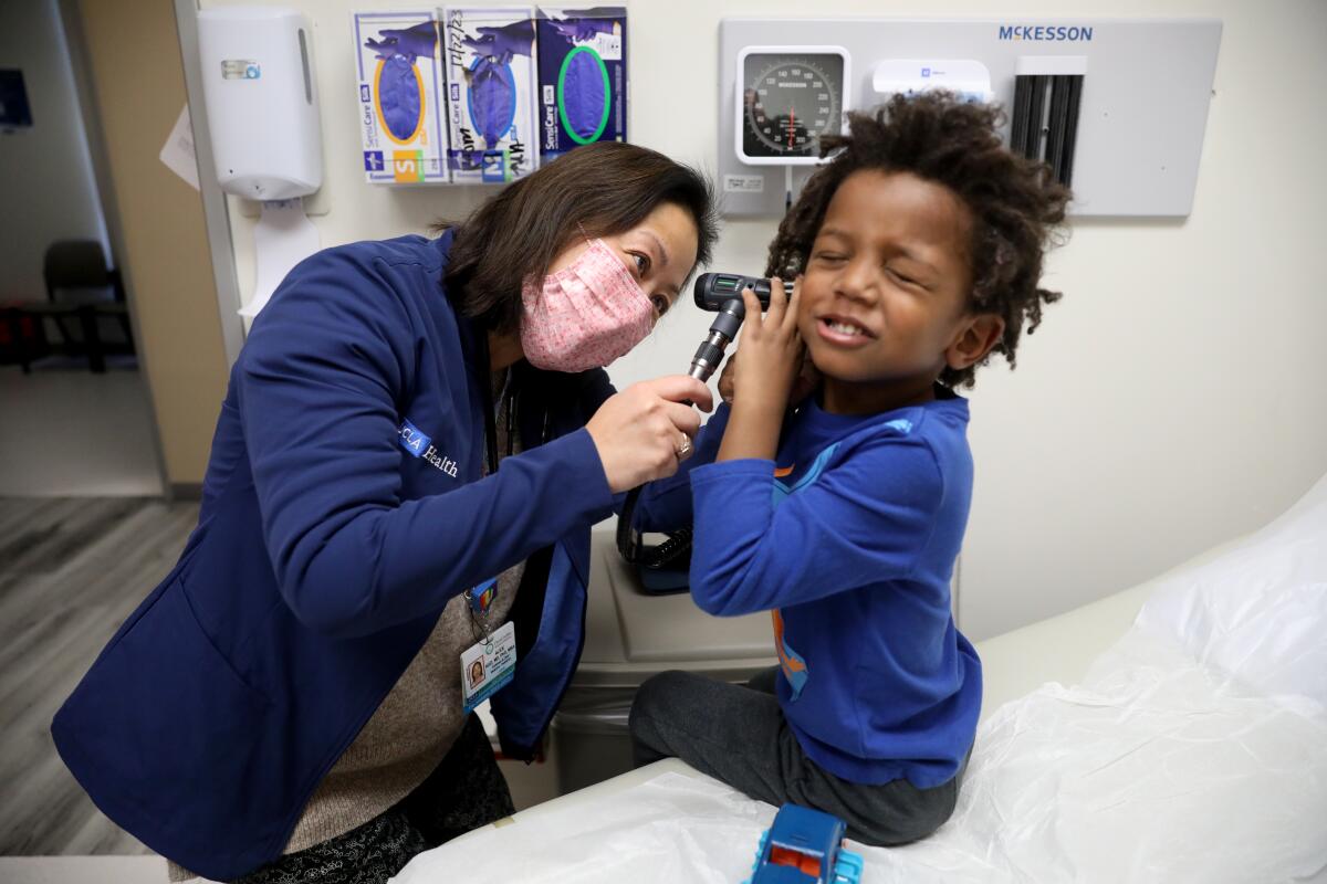 A doctor does a routine checkup for a 4-year-old patient.