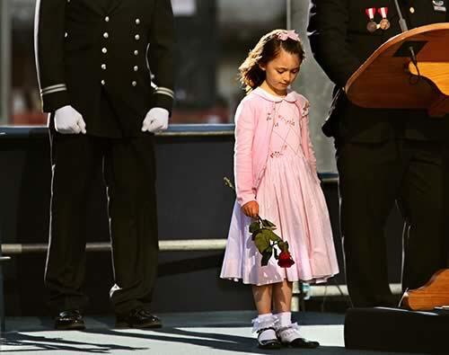 Seven-year-old Patricia Smith stands beside her father, James, at a ground zero memorial service as he spoke of her mother, a New York police officer who died in the Sept. 11 attacks. If his wife were alive, Smith said, "Moira would be about the business of living."