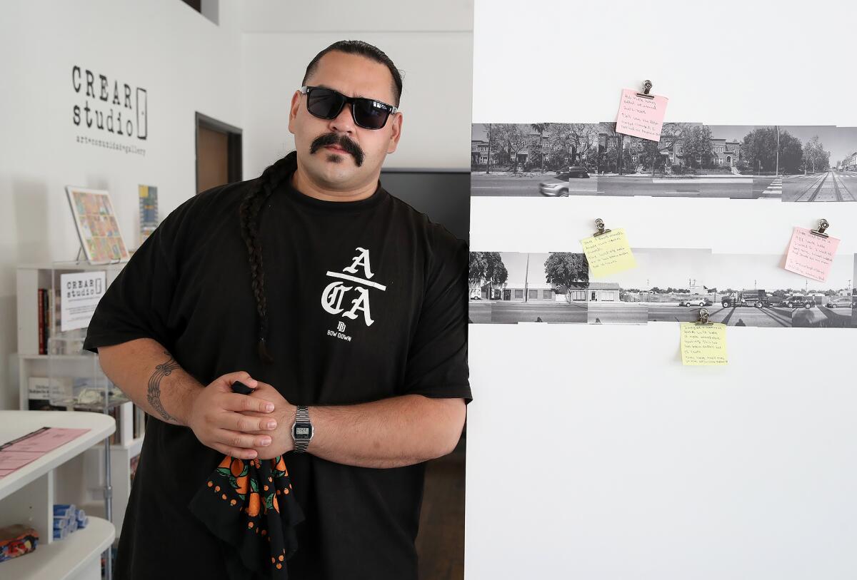 Anaheim-based documentary photographer Alkaid Ramirez stands with his project.