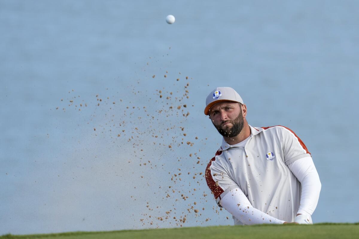 Team Europe's Jon Rahm hits from a bunker on the 12th hole during a four-ball match the Ryder Cup at the Whistling Straits Golf Course Saturday, Sept. 25, 2021, in Sheboygan, Wis. (AP Photo/Ashley Landis)