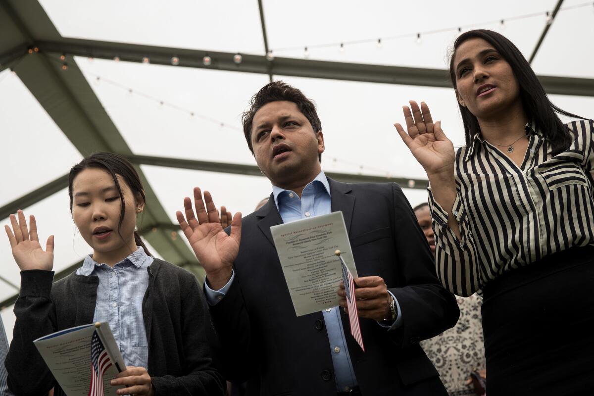 Immigrants take the oath of citizenship to the United States during a naturalization ceremony in New York City on June 16.