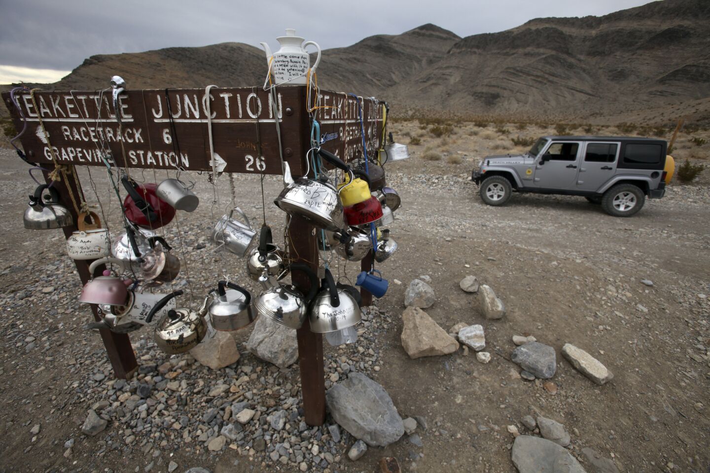 Teakettle Junction is a wide spot on Racetrack road and located six miles from the Racetrack. Travelers on the rough road hang teakettles on signage, creating a sort of open-air art installation.