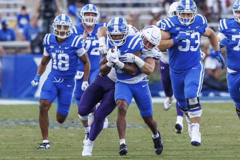 Duke's Travis Bates (19) is tackled by Northwestern's Aidan Hubbard (91) during the second half of an NCAA college football game in Durham, N.C., Saturday, Sept. 16, 2023. (AP Photo/Ben McKeown)