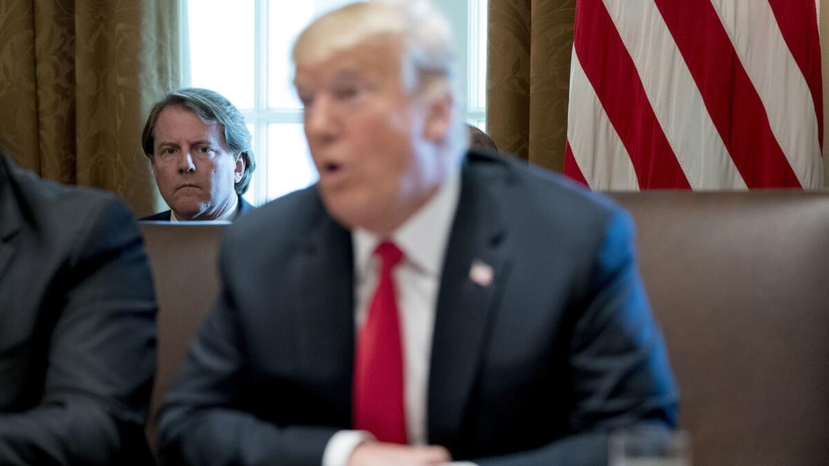 White House counsel Donald McGahn, background, listens as President Trump speaks during a Cabinet meeting on Aug. 16.