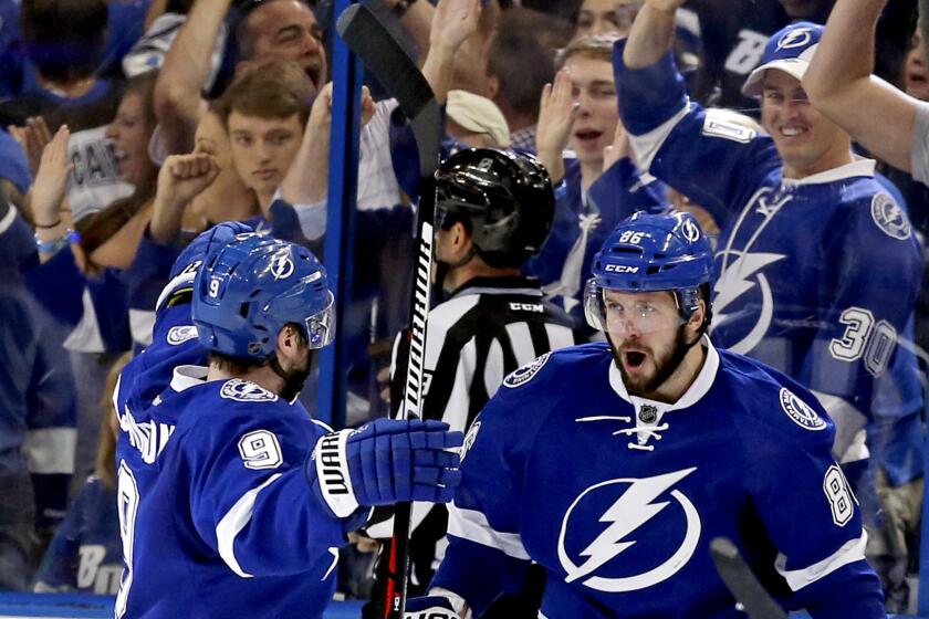 Tampa Bay's Nikita Kucherov, right, celebrates his goal against the Islanders with teammate Tyler Johnson (9) during the third period Sunday.