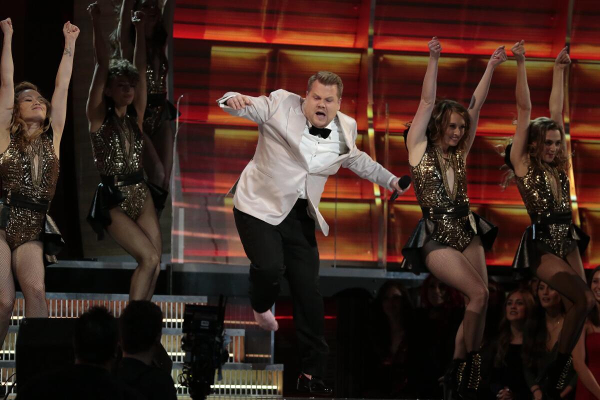 James Corden, dancing with a pink sock on his shoeless foot at the 59th Annual Grammy Awards.
