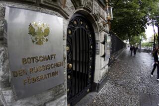 FILE - People walk past an entrance of the Russian embassy in Berlin, Germany, Friday, Sept. 4, 2020. Germany says it has told Russia to close four out of five consulates in Germany in a tit-for-tat move after Moscow set a limit for the number of German embassy staff and related bodies that can operate in Russia. (AP Photo/Michael Sohn, File)