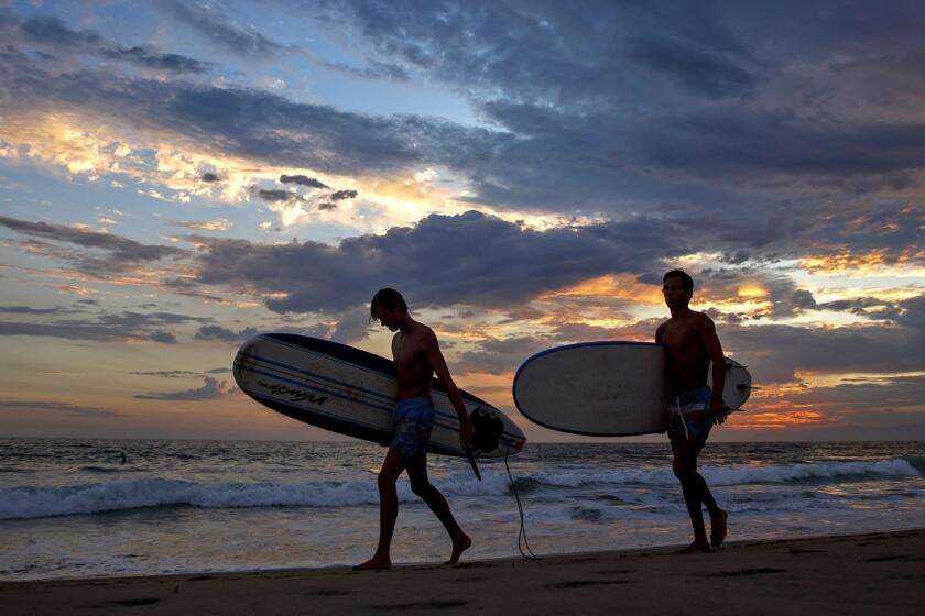A couple of locals end their day at a surfing spot.