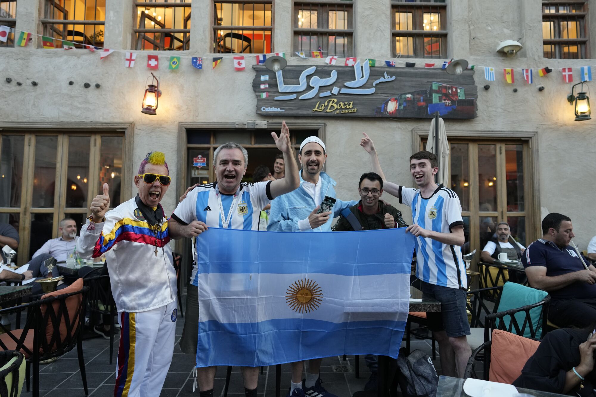 Fans of Argentina cheer for their team in Souq Waqif marke