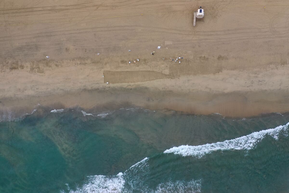 An aerial view of oil on the sand at Huntington Beach.