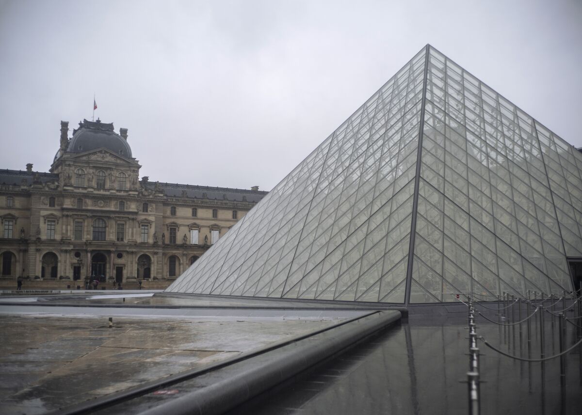 A view of the Louvre museum, in Paris, France, Sunday, March 1, 2020. The spreading coronavirus epidemic shut down France's Louvre Museum on Sunday, with workers who guard its trove of artworks fearful of being contaminated by the museum's flow of visitors from around the world. (AP Photo/Rafael Yaghobzadeh)