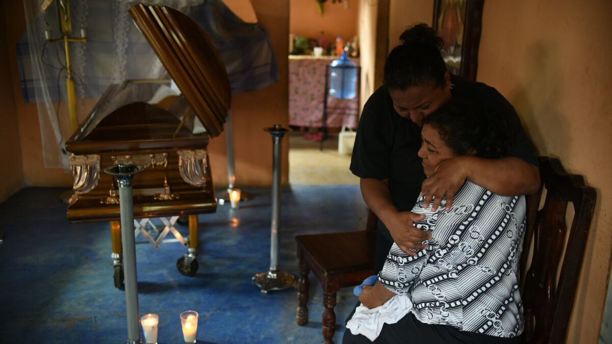 Relatives of the Mexican journalist Candido Rios Vazquez mourn next to his coffin.