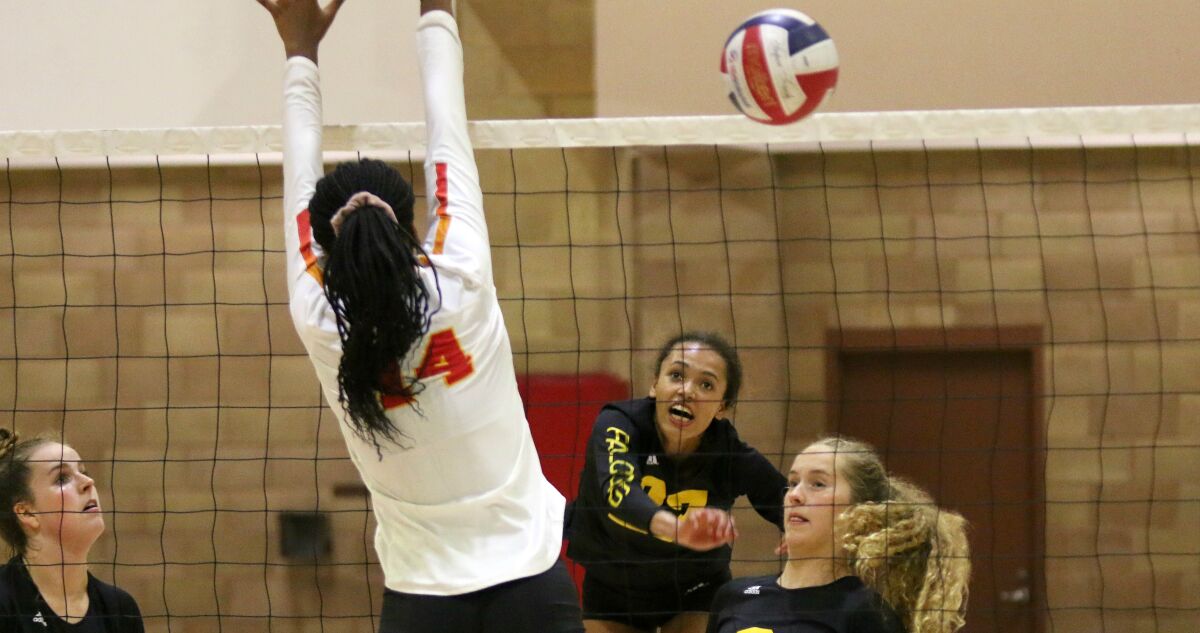 Satchell attacks the block in the 3-1 Falcon win over Cathedral Catholic.