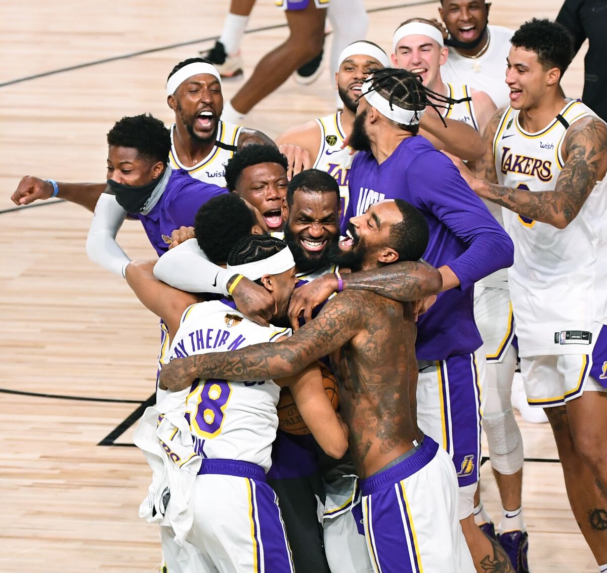 LeBron James, center, celebrates with his Lakers teammates.