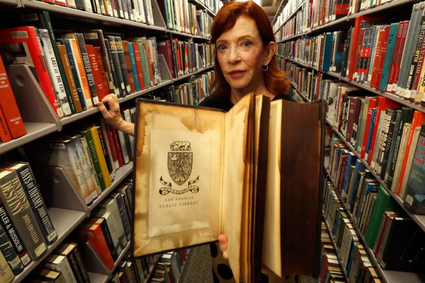 Susan Orlean has an upcoming book about the L.A. Public Library and the mysteries surrounding the devastating 1986 fire at the Central Library. She displays a book that was damaged in the fire.