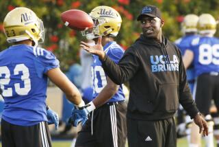 LOS ANGELES, CA - APRIL 6, 2017- UCLA football DeShaun Foster works with running backs.