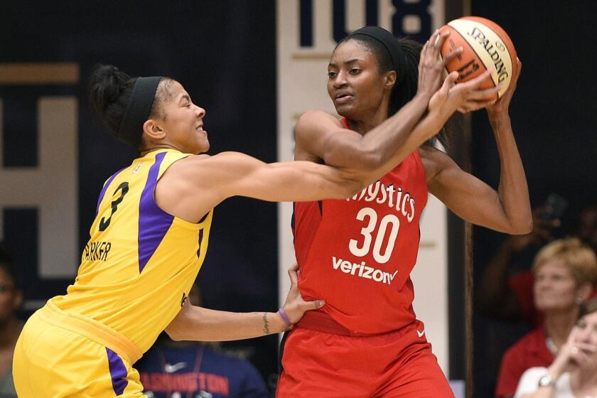 Los Angeles Sparks forward Candace Parker (3) reaches for the ball held by Washington Mystics forward LaToya Sanders (30) during the second half of a single-elimination WNBA basketball playoff game Thursday, Aug. 23, 2018, in Washington. The Mystics won 96-64. (AP Photo/Nick Wass)