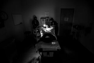 ALBUQUERQUE, NM - JUNE 23, 2022: A family physician, right, and her resident perform a surgical abortion on a 39-year-old woman who already has four children the day before the Supreme Court overturned Roe v. Wade at the Center for Reproductive Health clinic on June 23, 2022 in Albuquerque, New Mexico. New Mexico will see an influx of patients from neighboring states which have banned abortion. The doctor does not want to be identified for security reasons.(Gina Ferazzi / Los Angeles Times)