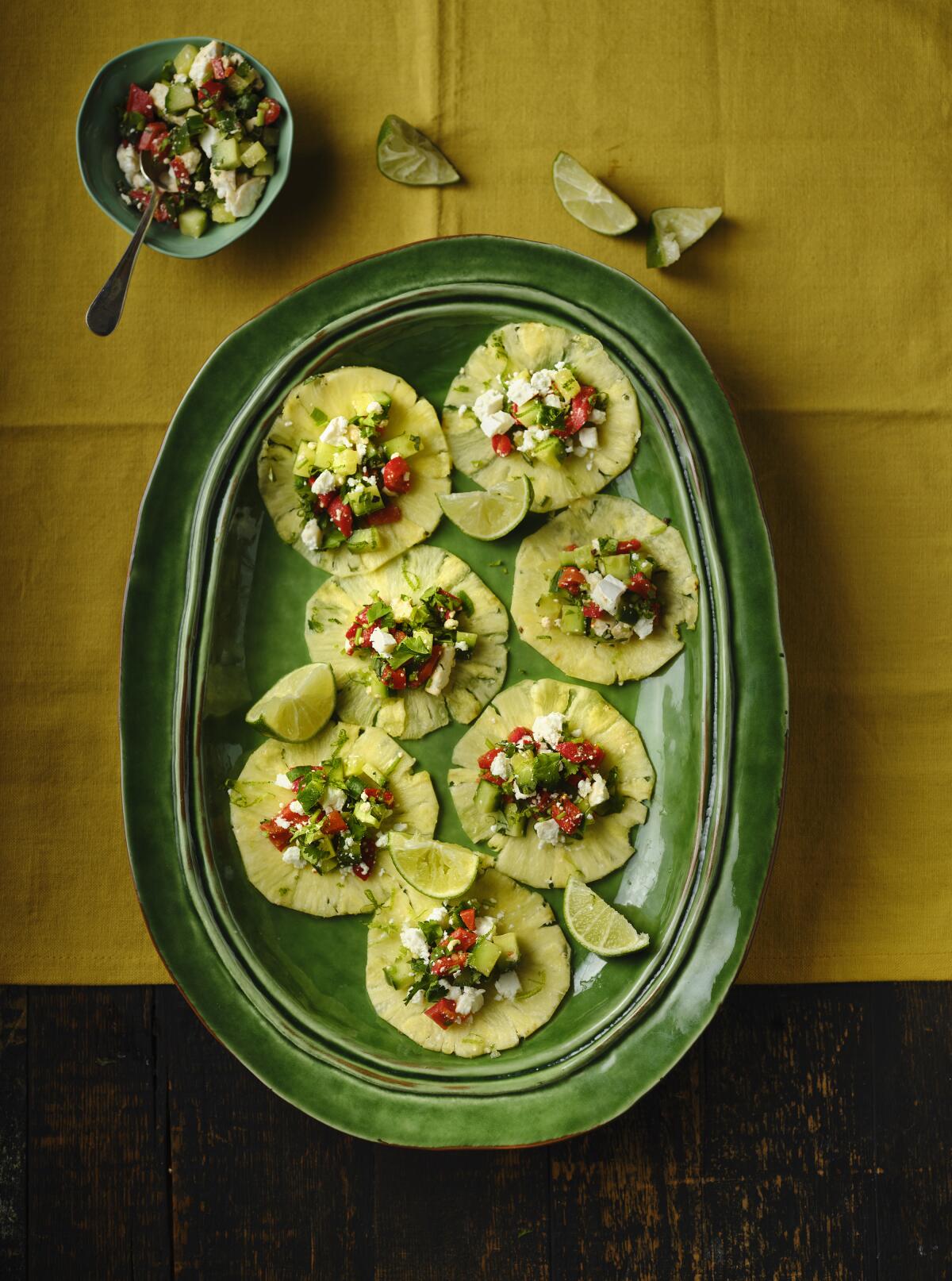 Veggie Pineapple Tacos are topped with cucumbers, red peppers or cherry tomatoes, cilantro, lime and Greek feta.