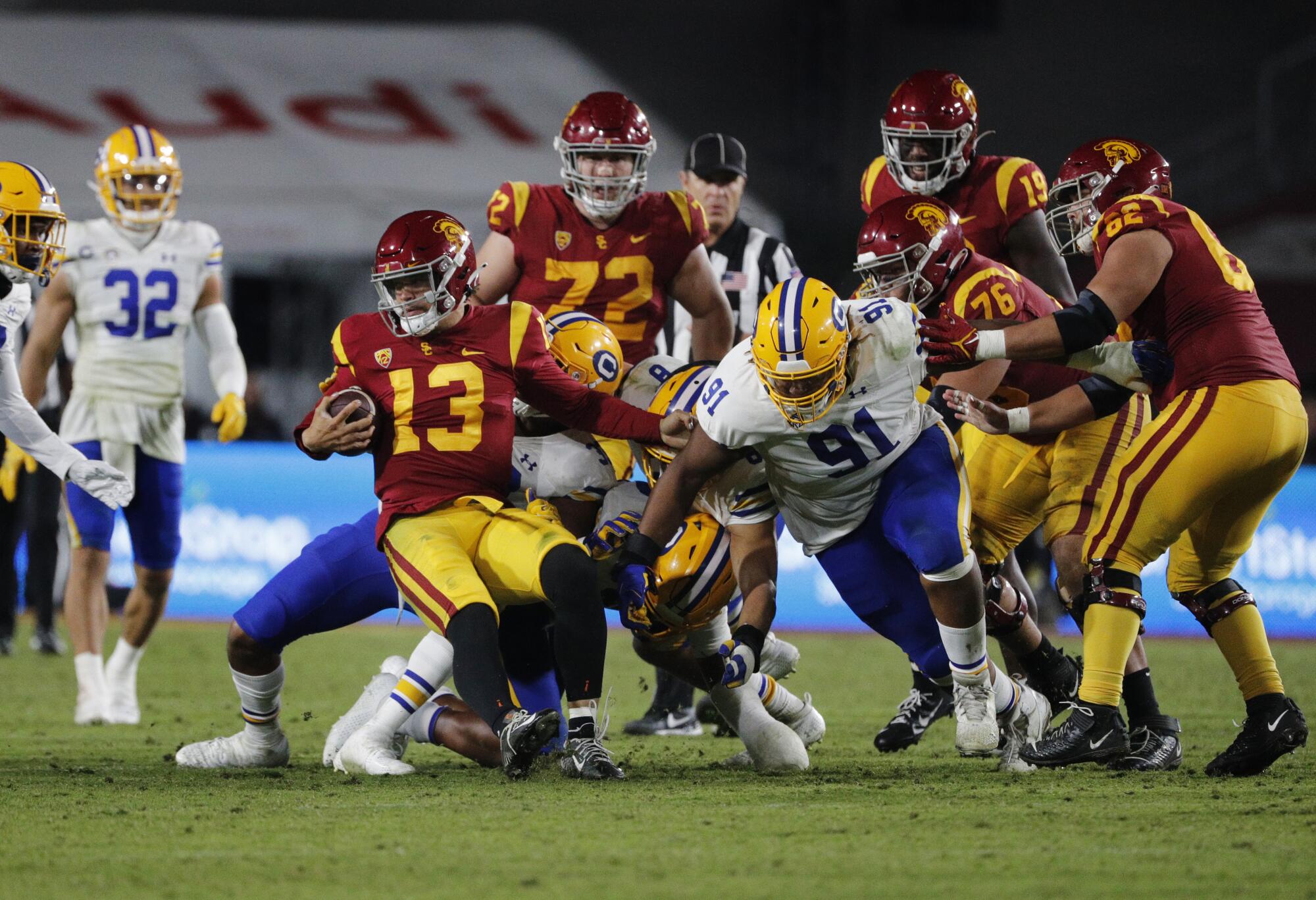 USC quarterback Caleb Williams carries the ball in the final moments of the game to secure a victory for the Trojans.