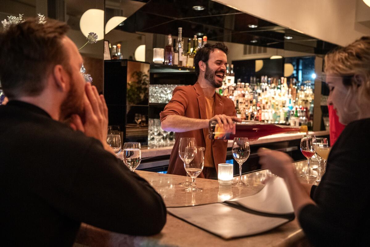 Pierluc Dallaire, Bar Restaurant's general manager and beverage director, serves customers in the bar area.