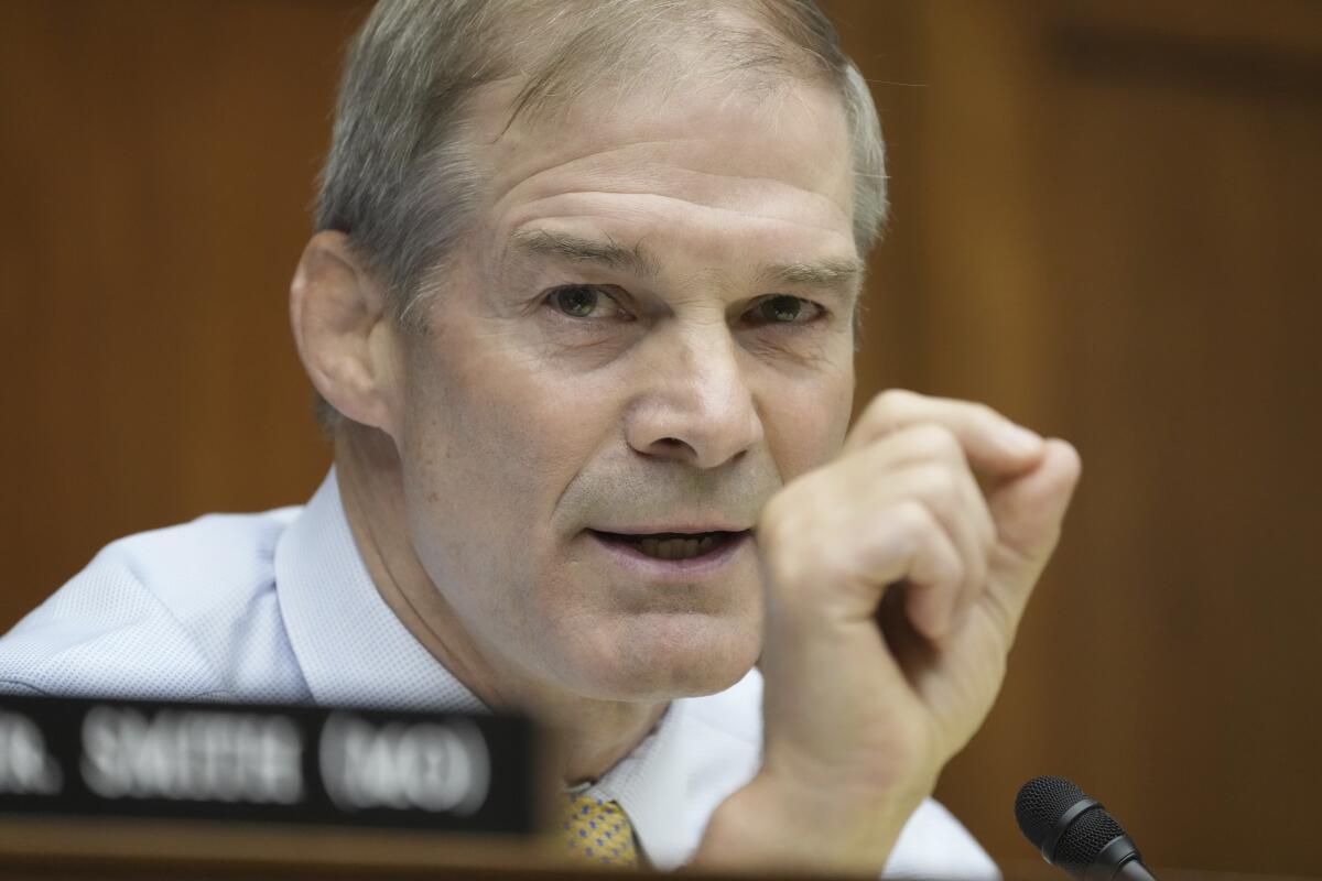 Rep. Jim Jordan pinches his thumb and index finger together and talks.
