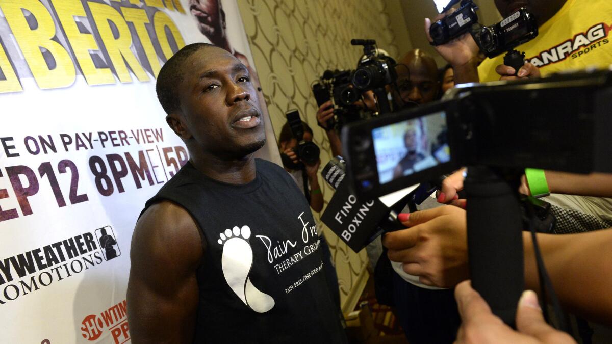 Former welterweight champion Andre Berto talks to reporters during a workout Aug. 28.
