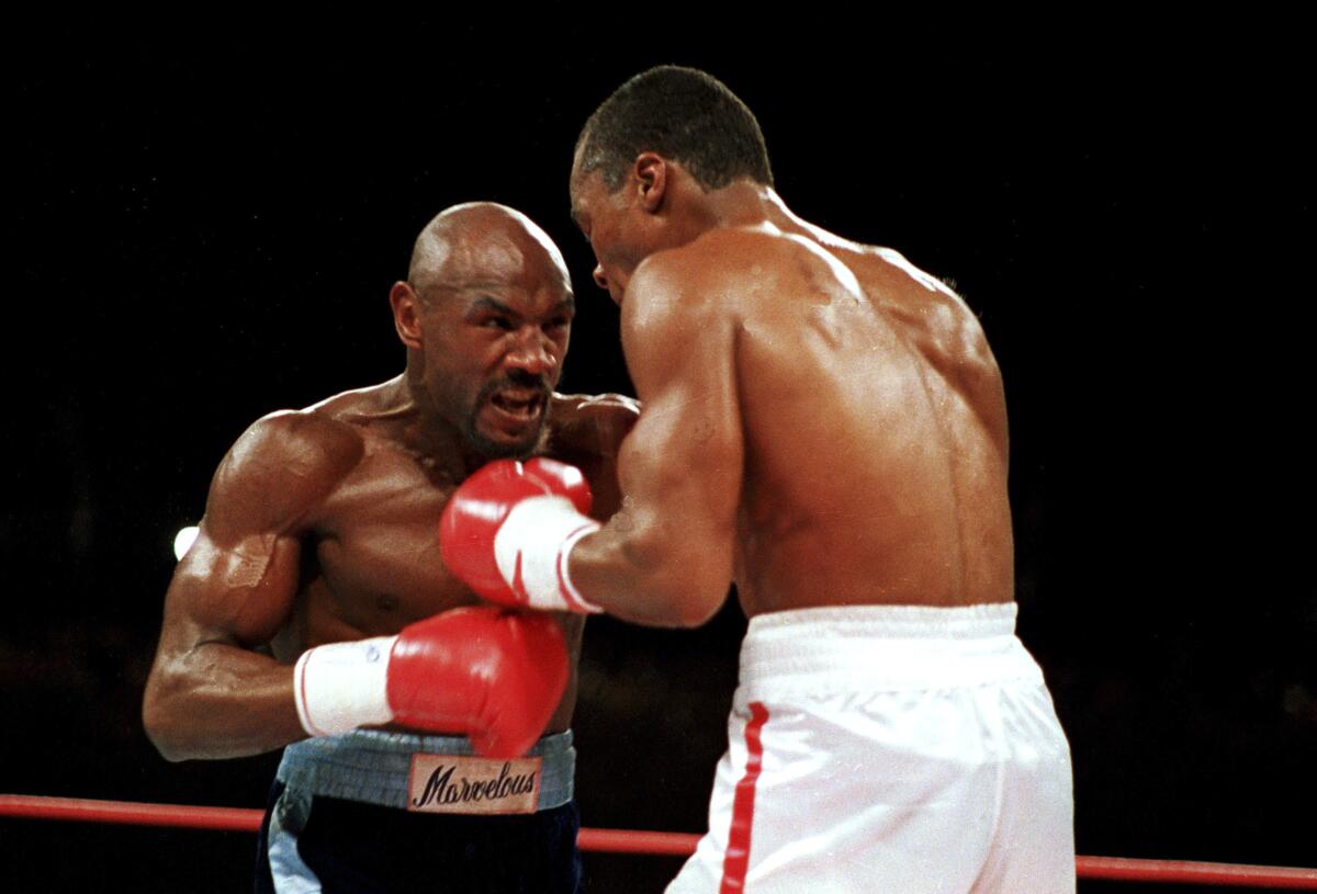 In this April 1987 photo, "Marvelous" Marvin Hagler, left, moves in on "Sugar" Ray Leonard in the third round in Las Vegas.