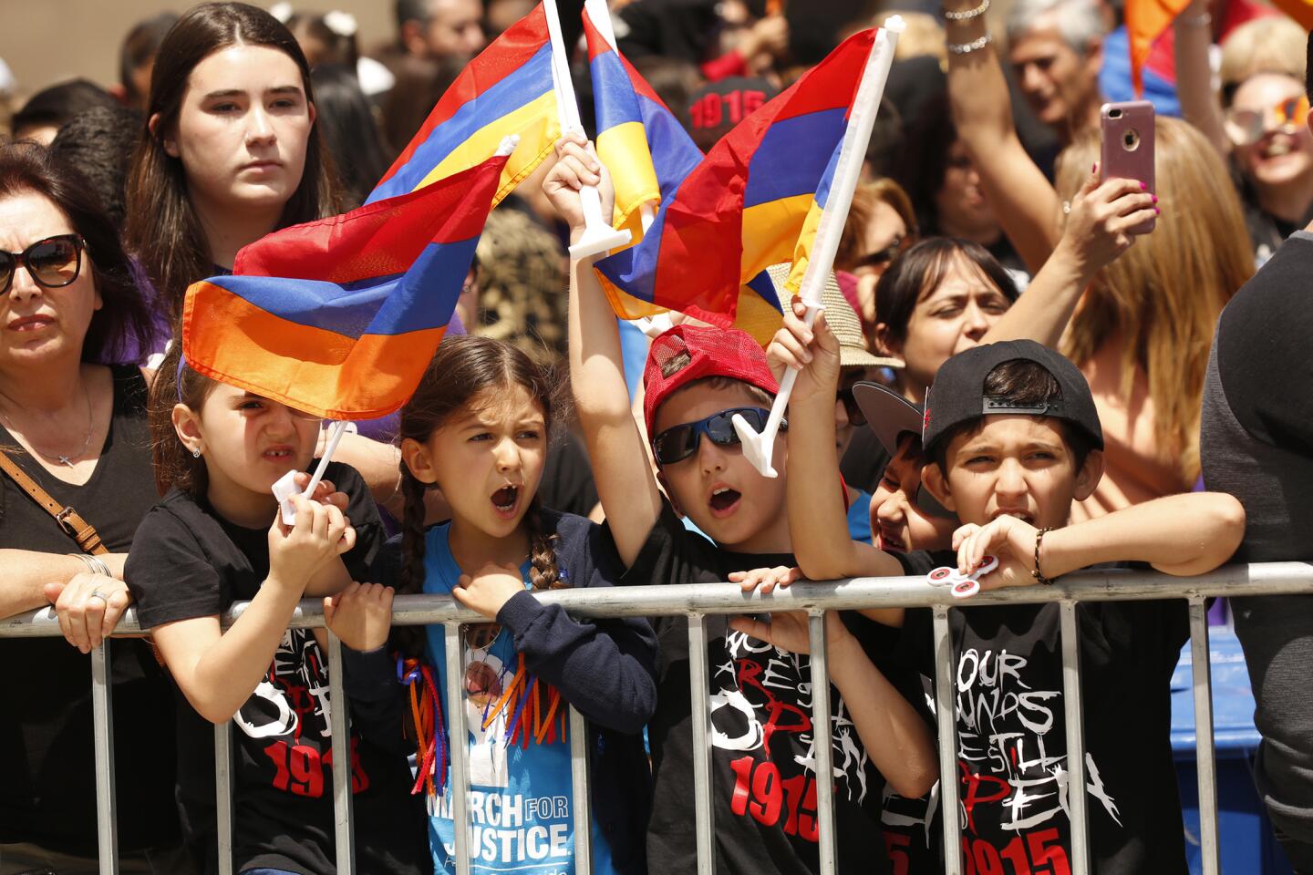 Children join the crowds gathered at the Turkish consulate in Los Angeles during a community march to mark the 102nd anniversary of the Armenian genocide.