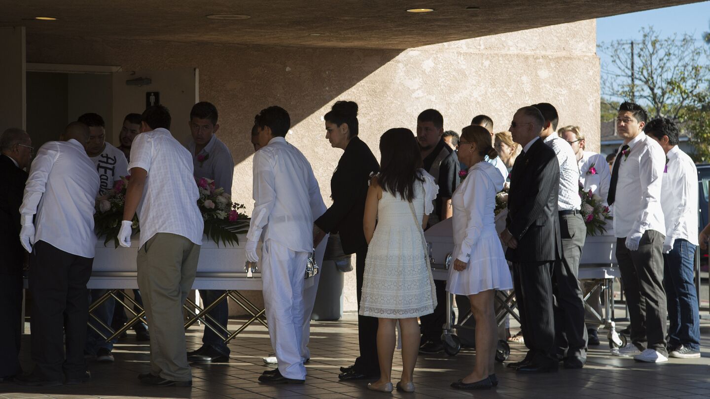 The caskets of twins Lexi and Lexandra Perez, two of three 13-year-old trick or treaters killed by a hit-and-run driver on Halloween night, are brought into Our Lady of Guadalupe Roman Catholic Church in Santa Ana for their funeral service Saturday.