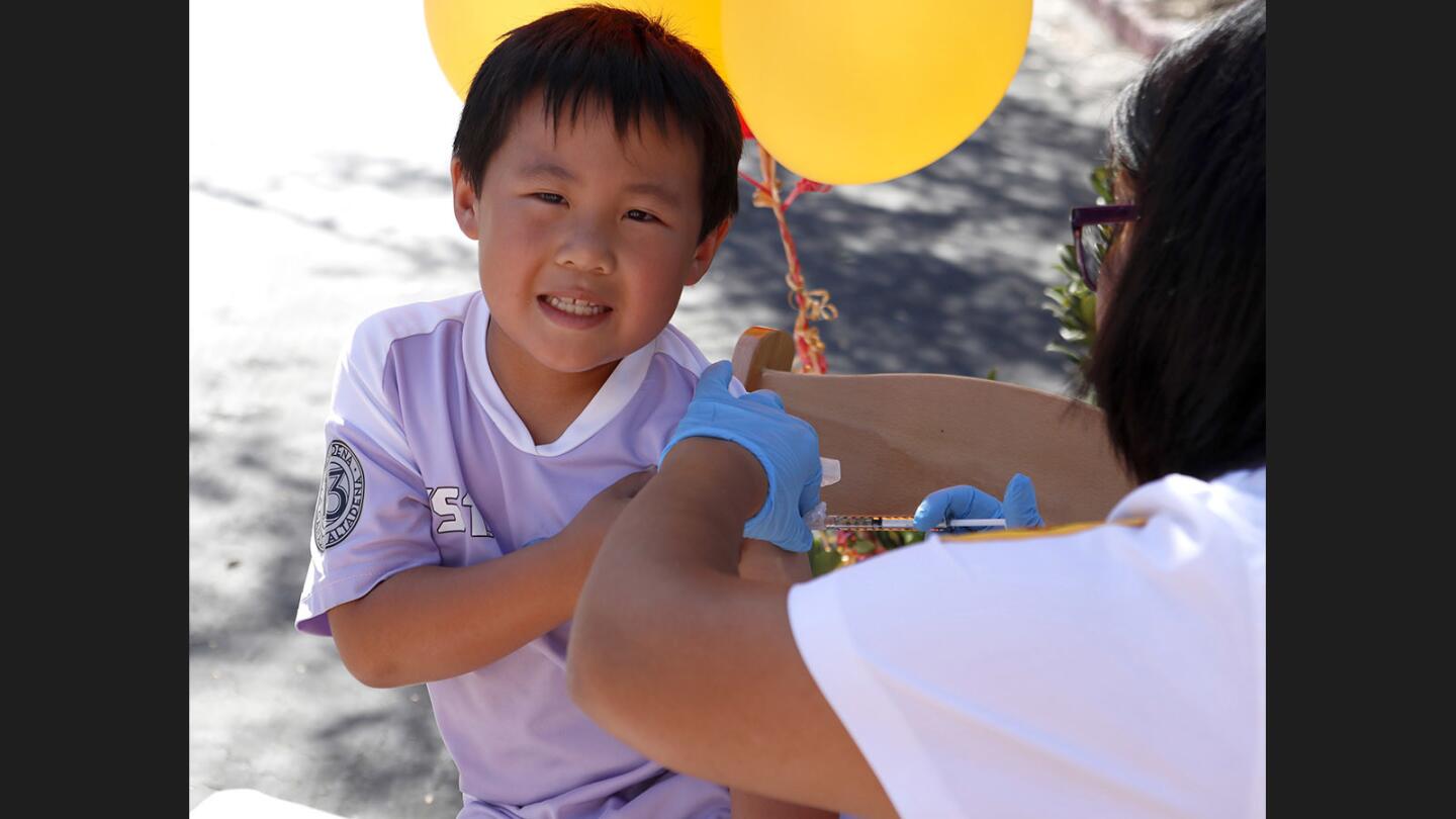 Dylan Ao, 6 of La Cañada Flintridge, gives a smile as he gets his flu shot at the annual USC Verdugo Hills Hospital Health Fair, at their location on Verdugo Blvd. in Glendale on Saturday, Oct. 21, 2017.
