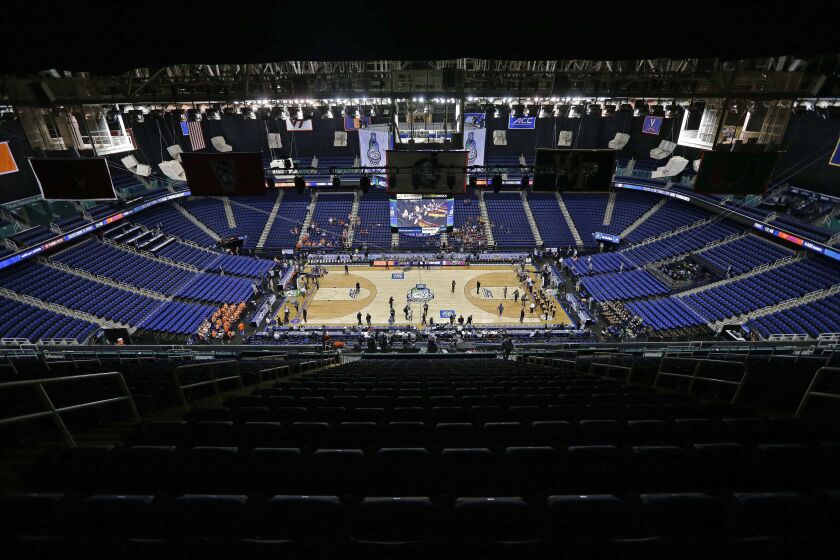 Greensboro Coliseum is mostly empty after the NCAA college basketball games were cancelled at the Atlantic Coast Conference tournament in Greensboro, N.C., Thursday, March 12, 2020. The biggest conferences in college sports all canceled their basketball tournaments because of the new coronavirus, seemingly putting the NCAA Tournament in doubt. (AP Photo/Gerry Broome)