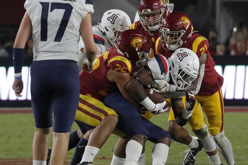 LOS ANGELES, CALIF. - OCT. 19, 2019. The USC defense stops Arizona running back Nathan Tilford in the fourth quarter at the Coliseum on Saturday night, Oct. 19, 2019. (Luis Sinco/Los Angeles Times)
