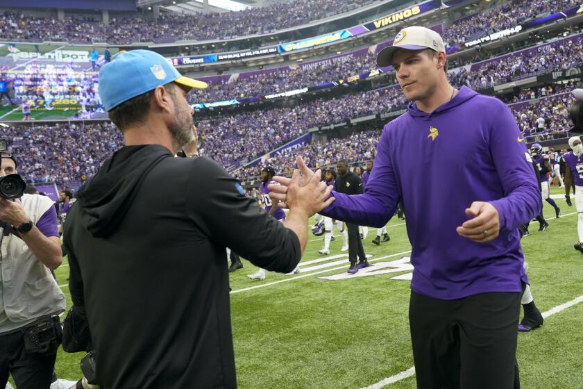 Los Angeles Chargers head coach Brandon Staley, left, greets Minnesota Vikings head coach Kevin O'Connell after an NFL football game, Sunday, Sept. 24, 2023, in Minneapolis. The Chargers won 28-24. (AP Photo/Abbie Parr)
