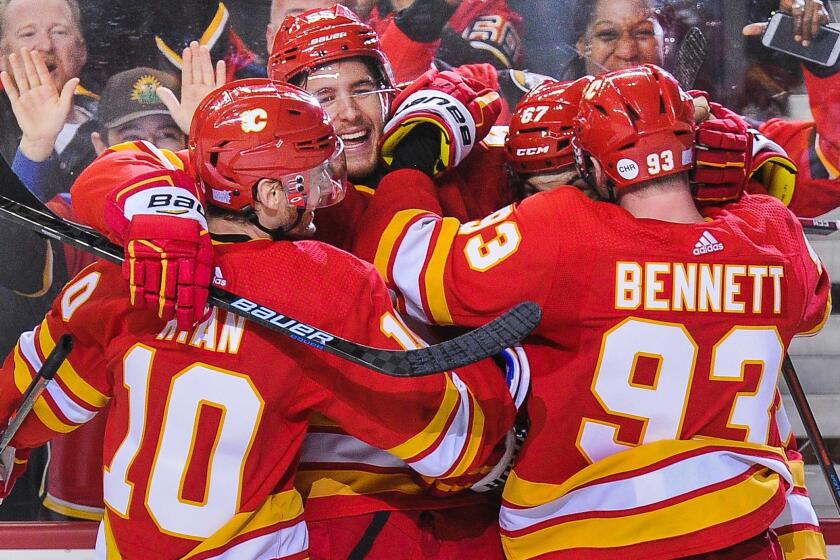 CALGARY, AB - NOVEMBER 3: Michael Frolik #67 (R) of the Calgary Flames celebrates after scoring the game-winning goal against the Chicago Blackhawks during an NHL game at Scotiabank Saddledome on November 3, 2018 in Calgary, Alberta, Canada. (Photo by Derek Leung/Getty Images) ** OUTS - ELSENT, FPG, CM - OUTS * NM, PH, VA if sourced by CT, LA or MoD **