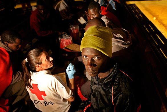 Spanish Red Cross personnel aid passengers of the rescue boat Alpheratz after it arrived in Los Cristianos on the island of Tenerife with 73 sub-Saharan immigrants. Officials said 14 African migrants died trying to reach Spain's Canary Islands by boat after they became lost.