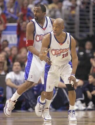 Clipper Sam Cassell, front, pumps his fist after hitting a shot as teammate Cuttino Mobley looks on.