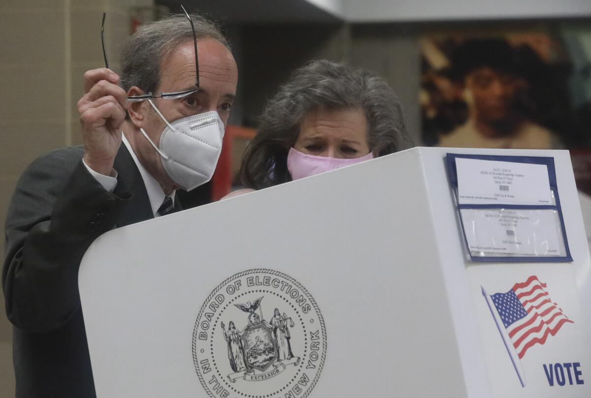 Rep. Eliot Engel, with his wife, Pat Ennis Engel, prepares to cast votes for primary elections June 30.