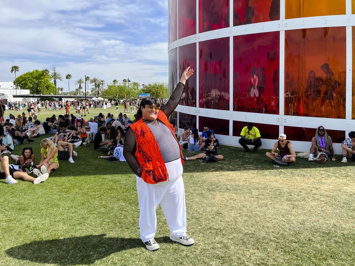Rolando Garcia standing on the grass at Coachella. 