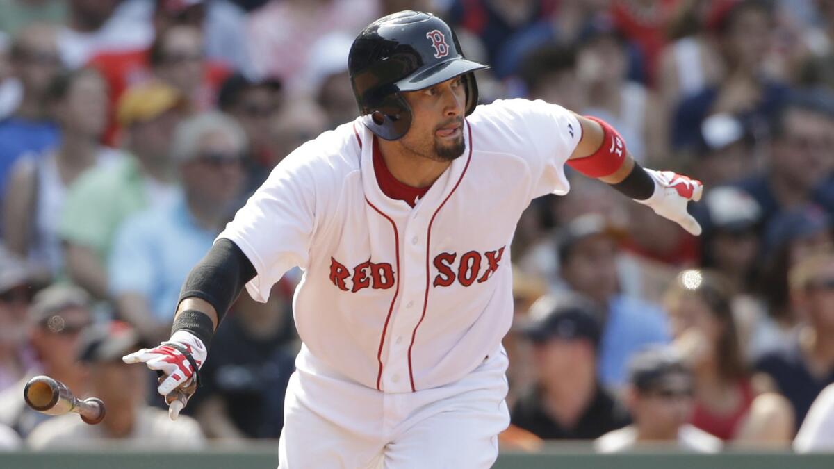 Shane Victorino hits a single for the Boston Red Sox during a game on July 12. Victorino was traded to the Angels on Monday.