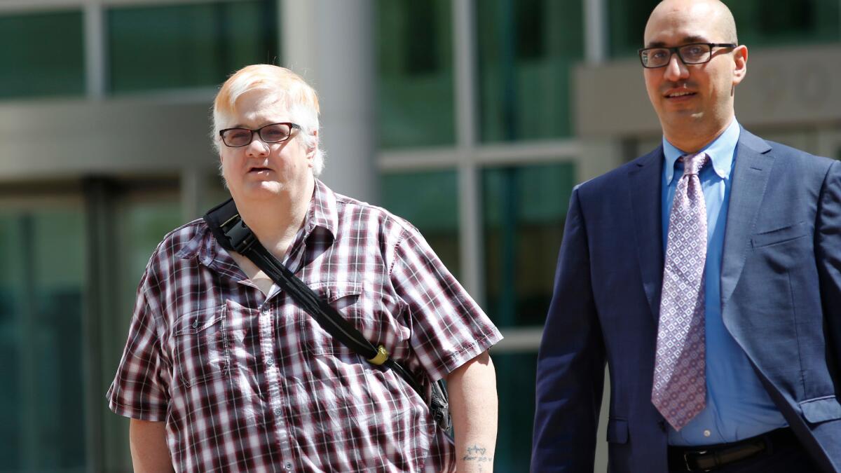 Dana Zzyym, left, and attorney Paul D. Castillo leave federal courthouse in Denver after delivering arguments in Zzyym's discrimination lawsuit.