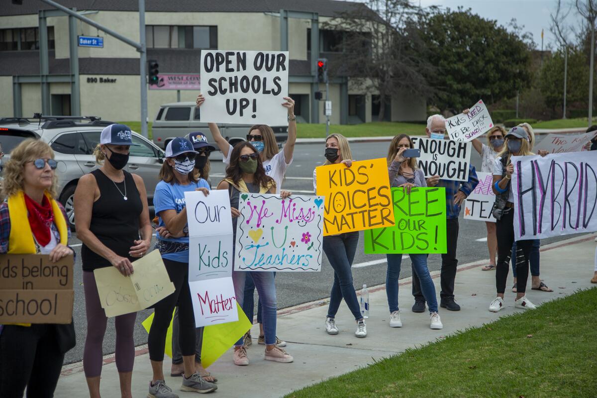 Students and parents protest outside the Newport-Mesa Unified School District office on Oct. 23.